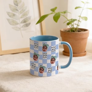 May include: A ceramic mug with a blue interior and handle. The exterior features a blue and white checkered pattern with baby photos and the text "best dad ever". A thoughtful gift for Father's Day or any special occasion.