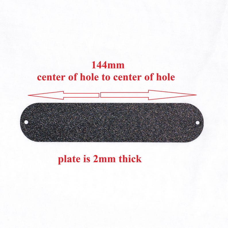 May include: A black, rectangular plate with rounded ends and a textured surface. The plate is 2mm thick and has two holes. The distance from the center of one hole to the other is 144mm.