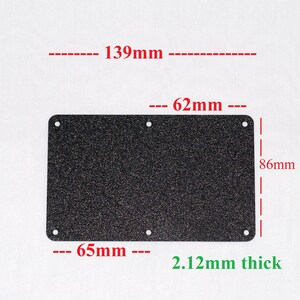 May include: A rectangular, dark speckled metal plate with rounded corners and six holes. The plate measures 5.47 inches long, 2.44 inches wide, and 3.39 inches high, with a thickness of 0.08 inches. The dimensions are labeled in the image.