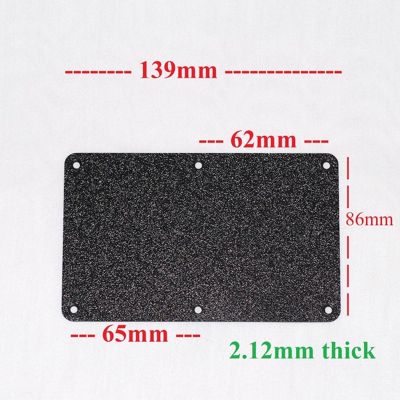 May include: A rectangular, dark speckled metal plate with rounded corners and six holes. The plate measures 5.47 inches long, 2.44 inches wide, and 3.39 inches high, with a thickness of 0.08 inches. The dimensions are labeled in the image.