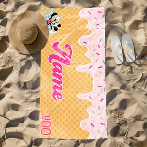 May include: A yellow and pink beach towel with a waffle pattern and a pink ice cream drip design. The towel features a cartoon image of Mickey Mouse and the text "Name #000".