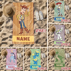 May include: Six different styles of beach towels featuring characters from the Toy Story movie franchise. The towels are striped in yellow and brown, with a character from the movie on each towel. The towels are personalized with the word "NAME" at the bottom.