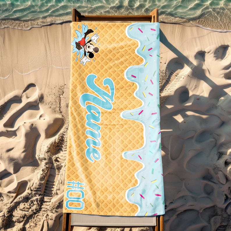May include: A yellow and blue beach towel with a waffle pattern and a blue ice cream drip design. Mickey Mouse is jumping out of the ice cream. The towel says "Name" and "#000".