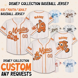 May include: Baseball jerseys from the Disney Collection. The jerseys are white with orange pinstripes and feature cartoon characters and names. The text on the jerseys includes "Marlin", "Nemo", and "Name". The jerseys are available in kid, youth, and adult sizes.