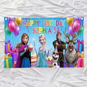 May include: A colorful birthday banner featuring characters from the movie Frozen. The banner reads "Happy Birthday Sophia 5" and includes images of Anna, Elsa, Kristoff, Olaf, and Sven, along with balloons and gifts.