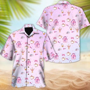 May include: A pink and blue button-up shirt with a repeating pattern of teacups, roses, and candles. The shirt has a gradient background that fades from pink to blue.