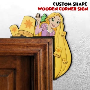 May include: A wooden corner sign featuring a cartoon of a princess with long blonde hair, a green frog, and floating lanterns. The sign is in the shape of the princess and includes the text "CUSTOM SHAPE WOODEN CORNER SIGN".