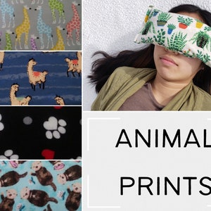 May include: Four different fabric swatches with animal prints. The first swatch features a light gray background with yellow, pink, and purple giraffes. The second swatch features a blue background with white llamas. The third swatch features a black background with white paw prints and red hearts. The fourth swatch features a light blue background with brown otters.