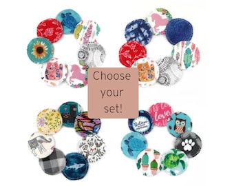 May include: Two sets of colorful reusable makeup remover pads with various patterns and designs. The pads are arranged in a circle with the text "Choose your set!" in the center.