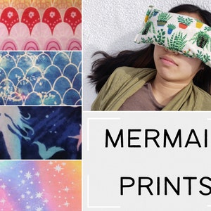 May include: Four different fabric swatches with mermaid-themed prints. The top swatch features a pink and red pattern with arches and flowers. The second swatch is a blue and white pattern with scales. The third swatch is a blue and white pattern with a mermaid silhouette. The bottom swatch is a pink, purple, and blue ombre pattern with white stars. The text "MERMAID PRINTS" is displayed below the swatches.