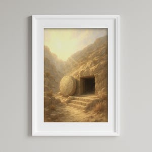 Op de afbeelding: Een ingelijste prent van een sepia-getinte landschap met een open graf met een grote weggerolde steen. De scène wordt verlicht door een helder licht van bovenaf, wat wijst op een spiritueel of historisch thema. Het kunstwerk is in een witte lijst.