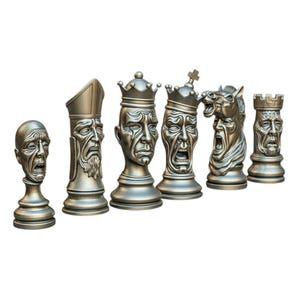 May include: A set of six chess pieces with detailed, expressive faces in a metallic bronze finish. The pieces include a pawn, bishop, king, queen, knight, and rook, each with unique facial expressions and headwear. The chess set is designed for display.