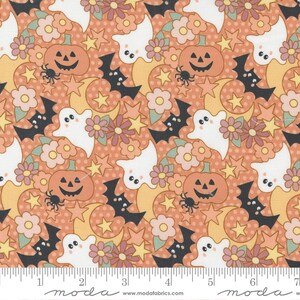May include: A fabric pattern featuring white ghosts, orange jack-o'-lanterns, black bats, yellow stars, and pink flowers on a polka-dot orange background. A white ruler at the bottom shows measurements in cm, with the text moda www.modafabrics.com.