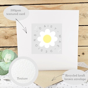 May include: A white greeting card with a textured surface, featuring a daisy logo and the text "DAISY MAE DESIGN". Includes a recycled kraft brown envelope. The card is made of 300gsm textured card.