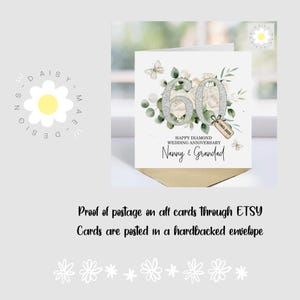 May include: A white greeting card for a 60th wedding anniversary, featuring a floral design with the numbers "60" in silver glitter. The card reads "Happy Diamond Wedding Anniversary" and "Nanny & Grandad."