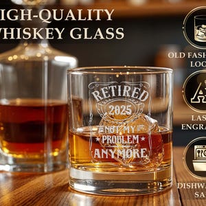 May include: A whiskey glass with the text "RETIRED 2025 NOT MY PROBLEM ANYMORE" etched on the front. The glass is filled with amber liquid and ice cubes. A decanter is in the background. The image also includes text that says "HIGH-QUALITY WHISKEY GLASS".