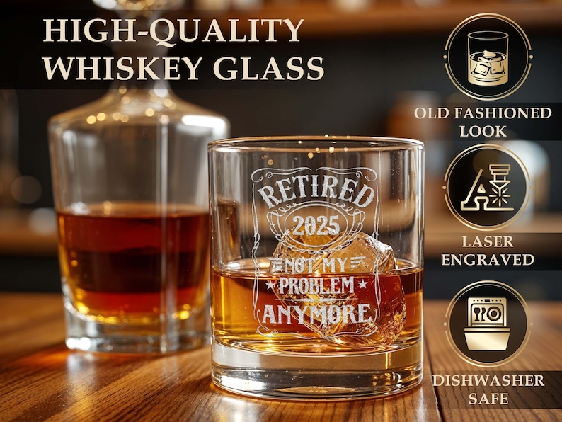May include: A whiskey glass with the text "RETIRED 2025 NOT MY PROBLEM ANYMORE" etched on the front. The glass is filled with amber liquid and ice cubes. A decanter is in the background. The image also includes text that says "HIGH-QUALITY WHISKEY GLASS".