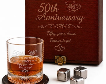 May include: A dark brown wooden box with a brass latch, engraved with 50th Anniversary, two rings, and the text Fifty years down. Forever to go!. Includes a clear glass tumbler with matching engraving, a dark coaster, and three metal ice cubes.