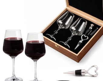 May include: Two wine glasses filled with red wine are displayed next to a wooden box containing two additional wine glasses. The box also holds a corkscrew and a bottle stopper with a heart-shaped handle. A separate corkscrew and bottle stopper are also visible.