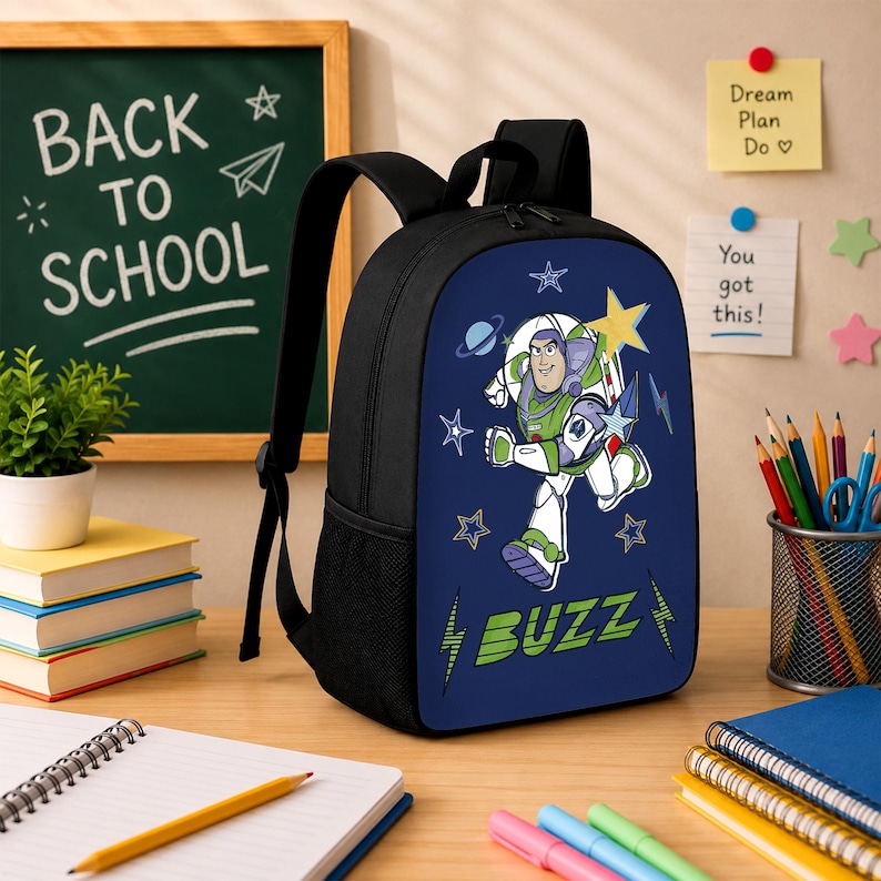 May include: A black backpack featuring a blue front panel with a graphic of Buzz Lightyear, stars, and planets. The text BUZZ is printed in green at the bottom. The backpack has black shoulder straps, a top handle, and side mesh pockets for storage.
