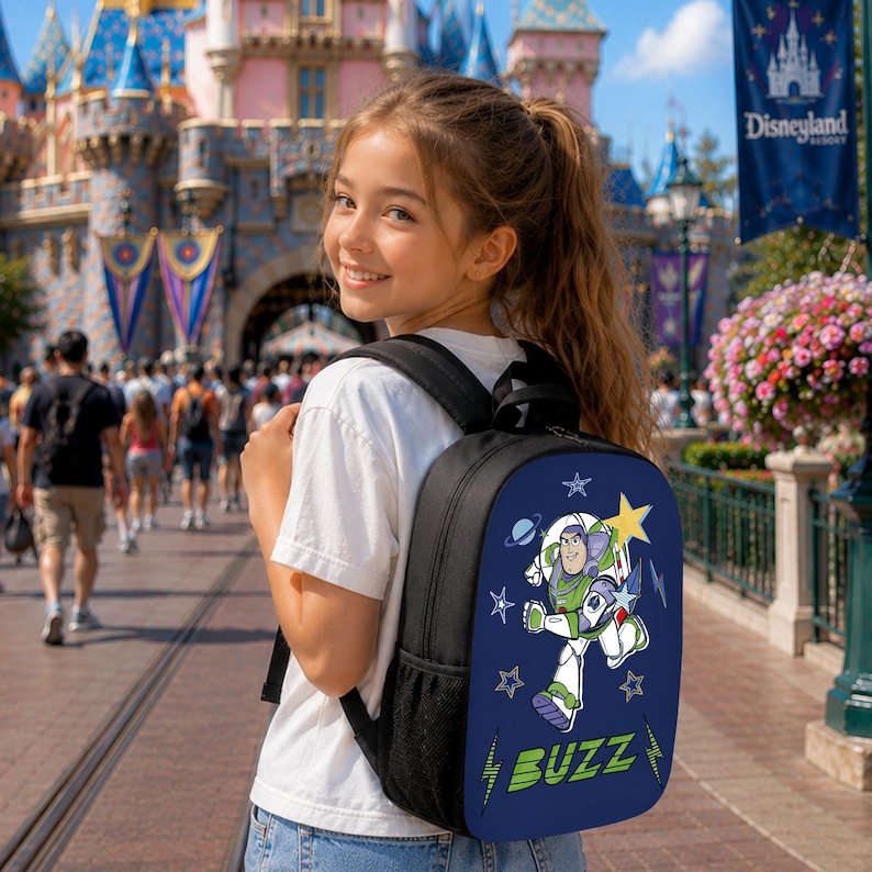 May include: A dark blue backpack featuring a graphic of the character Buzz Lightyear in a space suit, surrounded by stars and planets. The word BUZZ is printed in large green letters at the bottom. The bag has black straps and side mesh pockets.