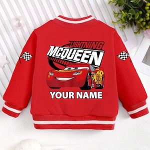 May include: Red and white baseball jacket with a Lightning McQueen graphic and the text "YOUR NAME".