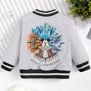 May include: A gray and black baseball style jacket with a colorful graphic of Mickey Mouse and the Disneyland Resort logo. The graphic features a compass with various attractions and landmarks from the resort.