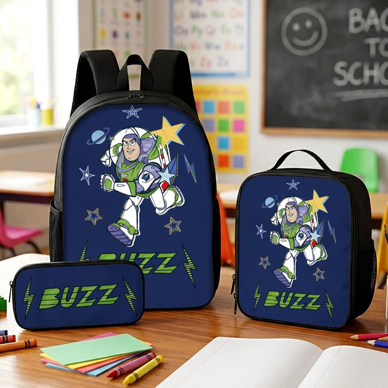 May include: A dark blue backpack, lunch bag, and pencil case set featuring a graphic of Buzz Lightyear in a white, green, and purple space suit. The design includes yellow stars, blue lightning bolts, and the text BUZZ in green lettering.
