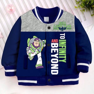 May include: A blue and grey bomber jacket with a cartoon image of Buzz Lightyear from Toy Story. The jacket has a white stripe around the collar and cuffs. The text "Buzz Lightyear Space Ranger" and "To Infinity and Beyond" is printed on the jacket.