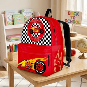 May include: Red Lightning McQueen backpack with black straps. Features a large graphic of Lightning McQueen with the number 95 and a checkered flag design. Includes a side pocket and flame graphics.