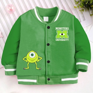 May include: Green and white baseball jacket with a Monsters University logo and a cartoon monster on the front.