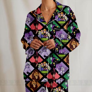 May include: A pajama set featuring a repeating pattern of Disney villains in a diamond grid. The long-sleeved top and pants have white trim and a black background. The villains include Ursula, Scar, and the Evil Queen.
