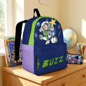 May include: A dark blue backpack featuring a graphic of Buzz Lightyear in a space suit, surrounded by stars and planets. The front pocket displays the text BUZZ in large green letters with lightning bolt accents. It has lime green and purple side panels.