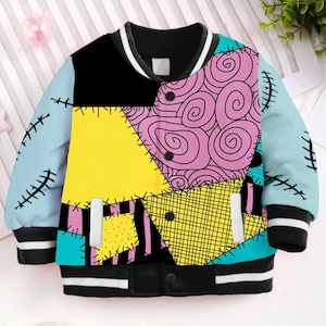 May include: A blue, yellow, pink, and black patterned bomber jacket with a black collar and white stripes on the sleeves and collar. The jacket has a button closure and two pockets.