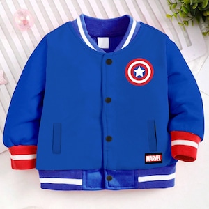 May include: A blue bomber jacket with red and white trim. It features a red, white, and blue Captain America logo on the front and a "MARVEL" logo on the bottom right.