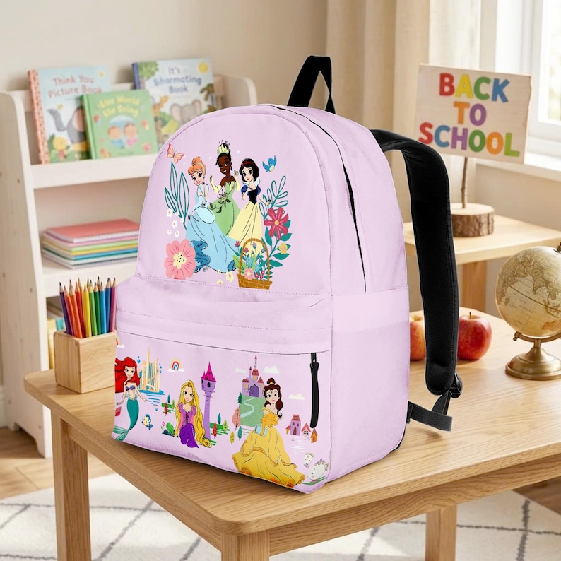 May include: A light purple backpack featuring illustrations of Disney princesses. The backpack has a black handle and straps, and a side pocket. The design includes images of princesses, flowers, and castles, with the words "Back to School" on a sign.
