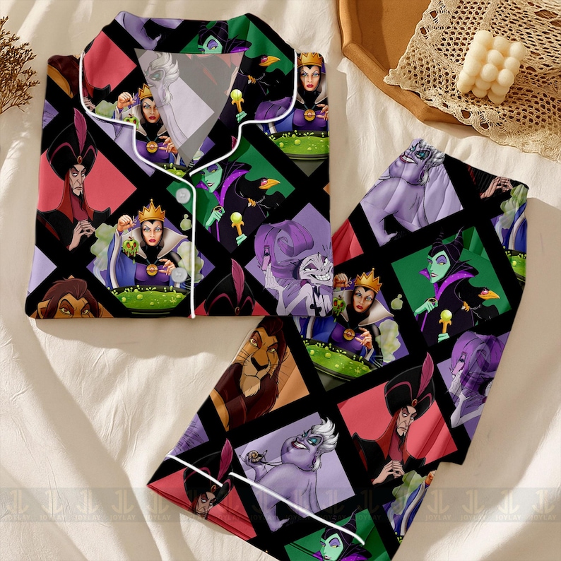May include: A two-piece pajama set featuring a colorful geometric pattern with various Disney villains. The long-sleeved top and pants are black with white trim and a button-down front. The design includes images of Ursula, Maleficent, and the Evil Queen.