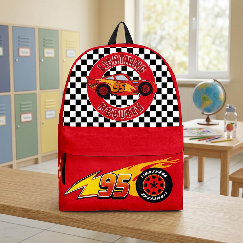 May include: Red backpack featuring Lightning McQueen from the Cars movie. The top section has a black and white checkered pattern with a circular image of the car and the text "LIGHTNING MCQUEEN 95". The bottom section has a yellow and red graphic with the number "95".