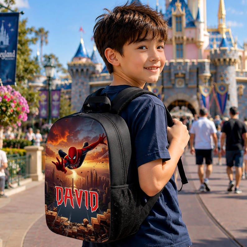 May include: A black backpack featuring a graphic print of the superhero Spider-Man in a dynamic pose against a sunset city skyline, with the name DAVID printed in bold red letters at the bottom, and black mesh side pockets.
