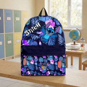 May include: A navy blue backpack featuring the character Stitch from Lilo & Stitch. The backpack has a tropical floral pattern with Stitch illustrations and the word "Stitch" in white. The backpack has a black handle and straps.