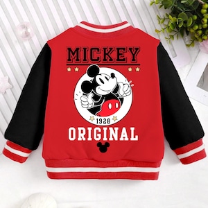 May include: Red and black baseball jacket with a Mickey Mouse graphic on the back. The graphic features Mickey Mouse with the text "Mickey Original 1928" and stars.