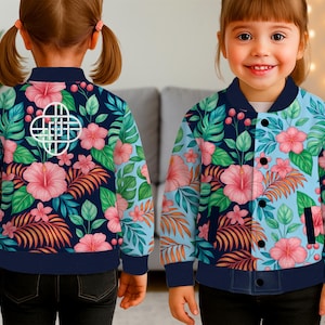 May include: A children's bomber jacket featuring a vibrant floral pattern with pink hibiscus flowers, green leaves, and orange accents against a navy blue and light blue background. The jacket has a navy blue collar, cuffs, and hem.