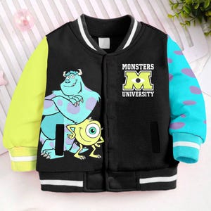 May include: Black, blue, and yellow varsity jacket with a Monsters University logo and images of Mike and Sully from the movie.