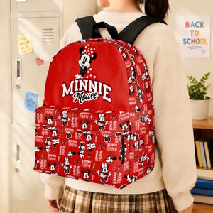 May include: Red Minnie Mouse backpack with a repeating pattern of Minnie Mouse illustrations and the words "MINNIE Mouse." The backpack has black straps and a large front pocket. The main design features Minnie Mouse in a polka dot bow.