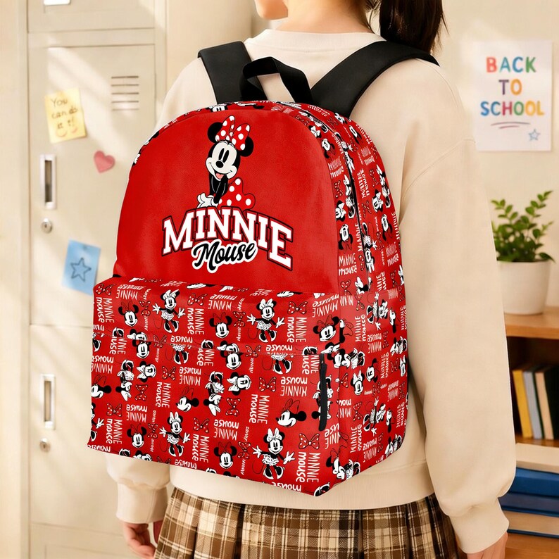 May include: Red Minnie Mouse backpack with a repeating pattern of Minnie Mouse illustrations and the words "MINNIE Mouse." The backpack has black straps and a large front pocket. The main design features Minnie Mouse in a polka dot bow.