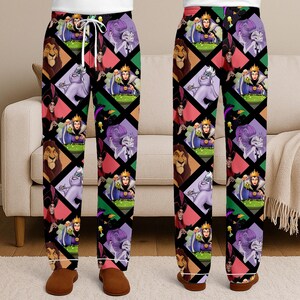 May include: Black pajama pants featuring a repeating pattern of Disney villains in diamond shapes. The characters include Scar, Ursula, the Evil Queen, and Jafar. The pants have a white drawstring and cuffs.