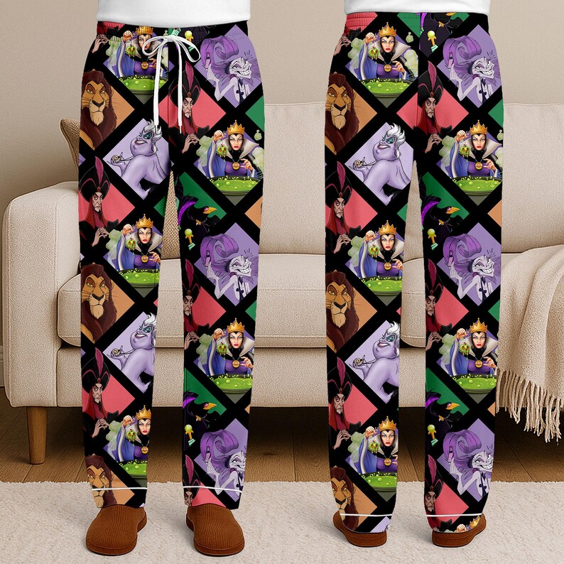 May include: Black pajama pants featuring a repeating pattern of Disney villains in diamond shapes. The characters include Scar, Ursula, the Evil Queen, and Jafar. The pants have a white drawstring and cuffs.