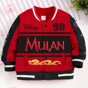 May include: Red and black baseball jacket with a white stripe on the collar and cuffs. The jacket has a black panel with the words "Disney Mulan" and the number "98" in white. A gold dragon is printed on the bottom of the jacket.