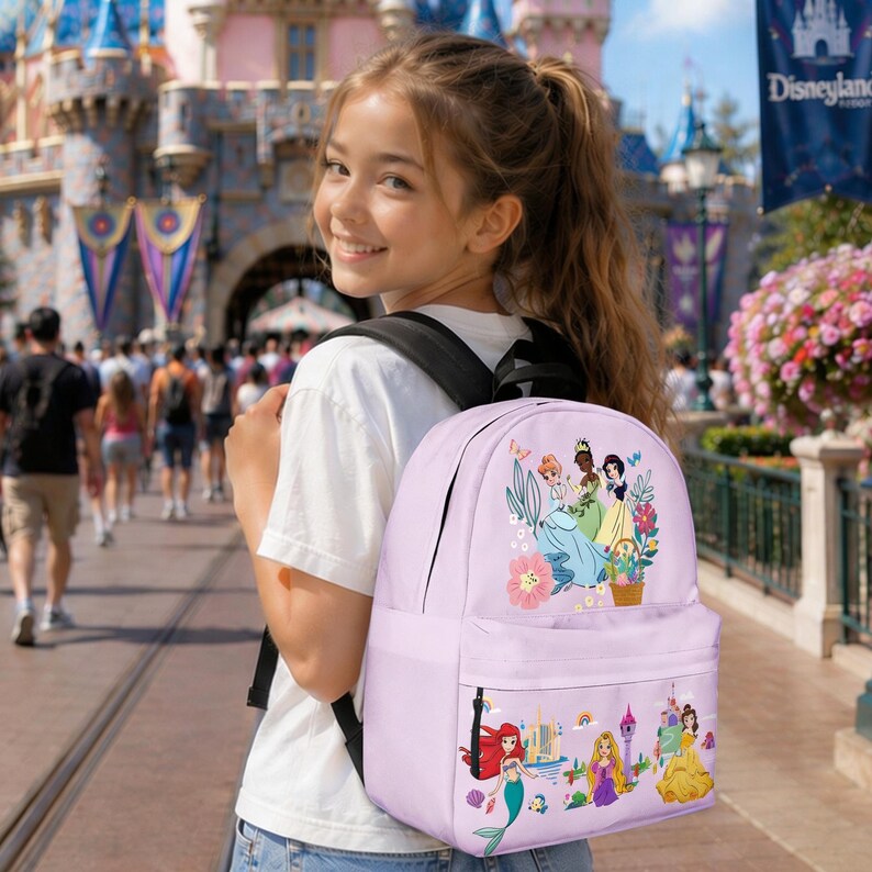 May include: A light purple backpack featuring Disney princesses. The backpack has a large front pocket and a smaller side pocket. The main design includes illustrations of several princesses with floral accents and a rainbow.