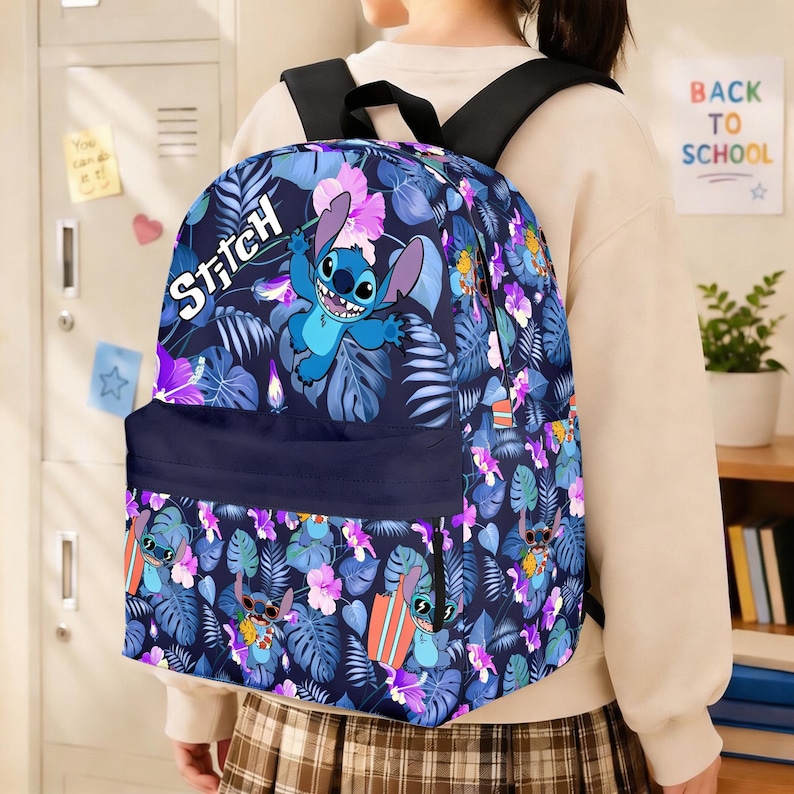 May include: A blue backpack featuring the character Stitch from Lilo & Stitch, surrounded by a floral pattern of purple and blue leaves and flowers. The word "Stitch" is printed in white. The backpack has black straps and a navy blue front pocket.